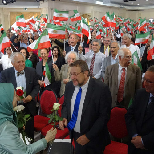 Maryam Rajavi offers flowers to political dignitaries at the celebration of the Relocation of Camp Liberty residents