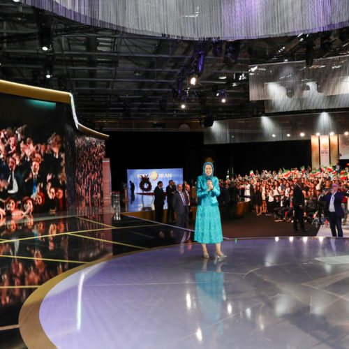 Maryam Rajavi and audience in Free Iran gathering applaud live contact with PMOI freedom-fighters in Albania, Villepinte, July 1, 2017