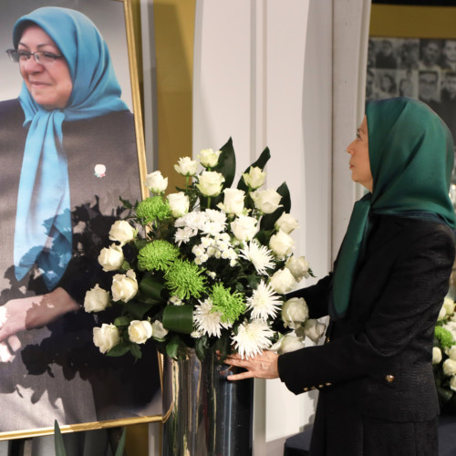 Putting flowers for Behnaz Mojalal, a member of PMOI who recently passed away