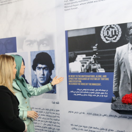 Maryam Rajavi and Mrs. Monika Kryemadhi standing before the portrait of Prof. Kazem Rajavi in the Exhibition of 120 Years of Iranian People’s Struggle for Freedom