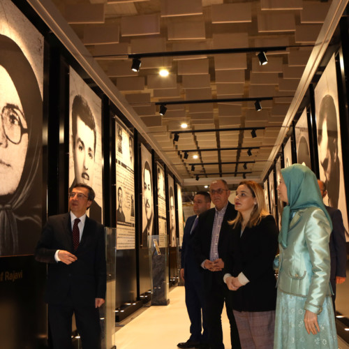 Maryam Rajavi, Monika Kryemadhi and her accompanying delegation visit the exhibition of 120 years of the Iranian people’s struggle for freedom - standing before the portrait of Ashraf Rajavi