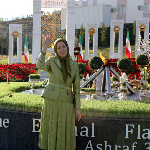 Maryam Rajavi standing beside the New Year Haft Sin arrangement and the beacon of freedom, Nowruz 1399