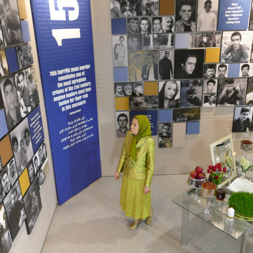 Visiting the Exhibition on 120 years of struggle of the people of Iran for freedom on the eve of the New Persian Year, Maryam Rajavi stands in front of the pictures of 1,500 martyrs of the Iran Uprising in November 2019