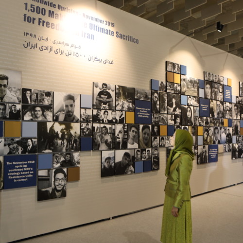 Visiting the Exhibition on 120 years of struggle of the people of Iran for freedom on the eve of the New Persian Year, Maryam Rajavi stands in front of the pictures of 1,500 martyrs of the Iran Uprising in November 2019