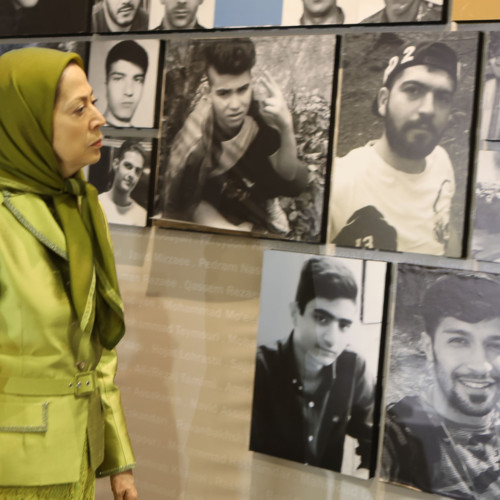 Visiting the Exhibition on 120 years of struggle of the people of Iran for freedom on the eve of the New Persian Year, Maryam Rajavi stands in front of the pictures of 1,500 martyrs of the Iran Uprising in November 2019