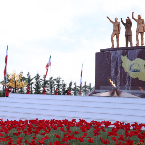 Maryam Rajavi standing in front of monument dedicated to Iran uprising and youth rising up against the mullahs’ dicatorship – Ashraf 3, July 17, 2020.