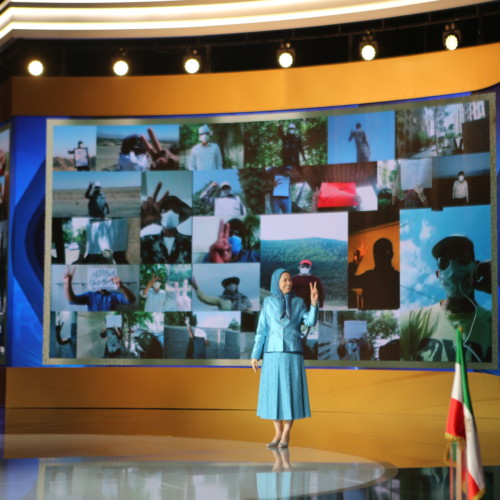Maryam Rajavi at the Free Iran Global Summit standing in front of collage of Resistance Units in Iran – Ashraf 3, July 17, 2020.