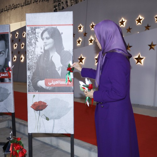 Pinning a flower to the portrait of Mahsa Amini, Iran’s brave daughter from Kurdistan, who lost her life after being brutalized by the regime’s mercenaries.