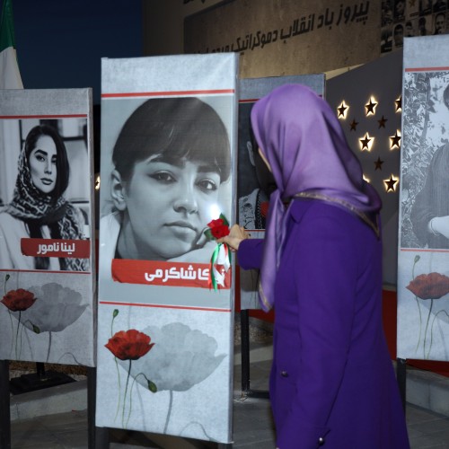 Pinning a rose to the image of Nika Shakarami, the brave 16-year-old girl who laid down her life for Iran’s freedom