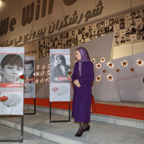 Pinning a rose to the image of Nika Shakarami, the brave 16-year-old girl who laid down her life for Iran’s freedom