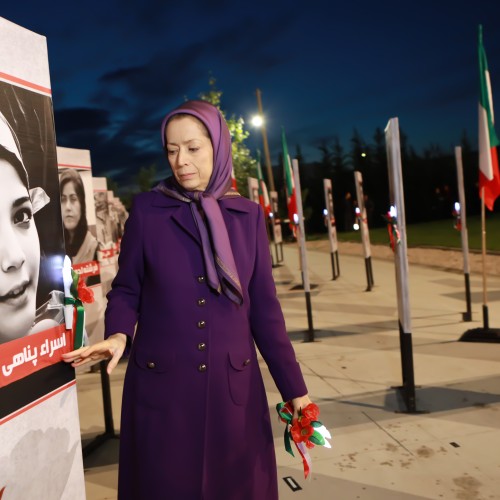 Posting a flower on the image of Asra Panahi, the brave high school student, who was killed during the uprising.