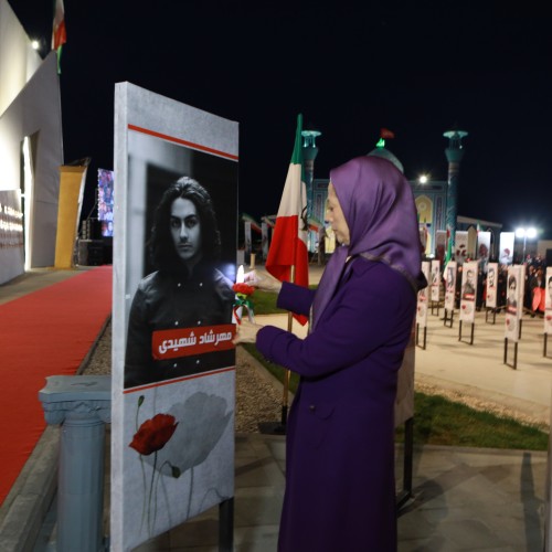 Pinning a rose to the image of Mehrshad Shahidi who was killed in Karaj. 